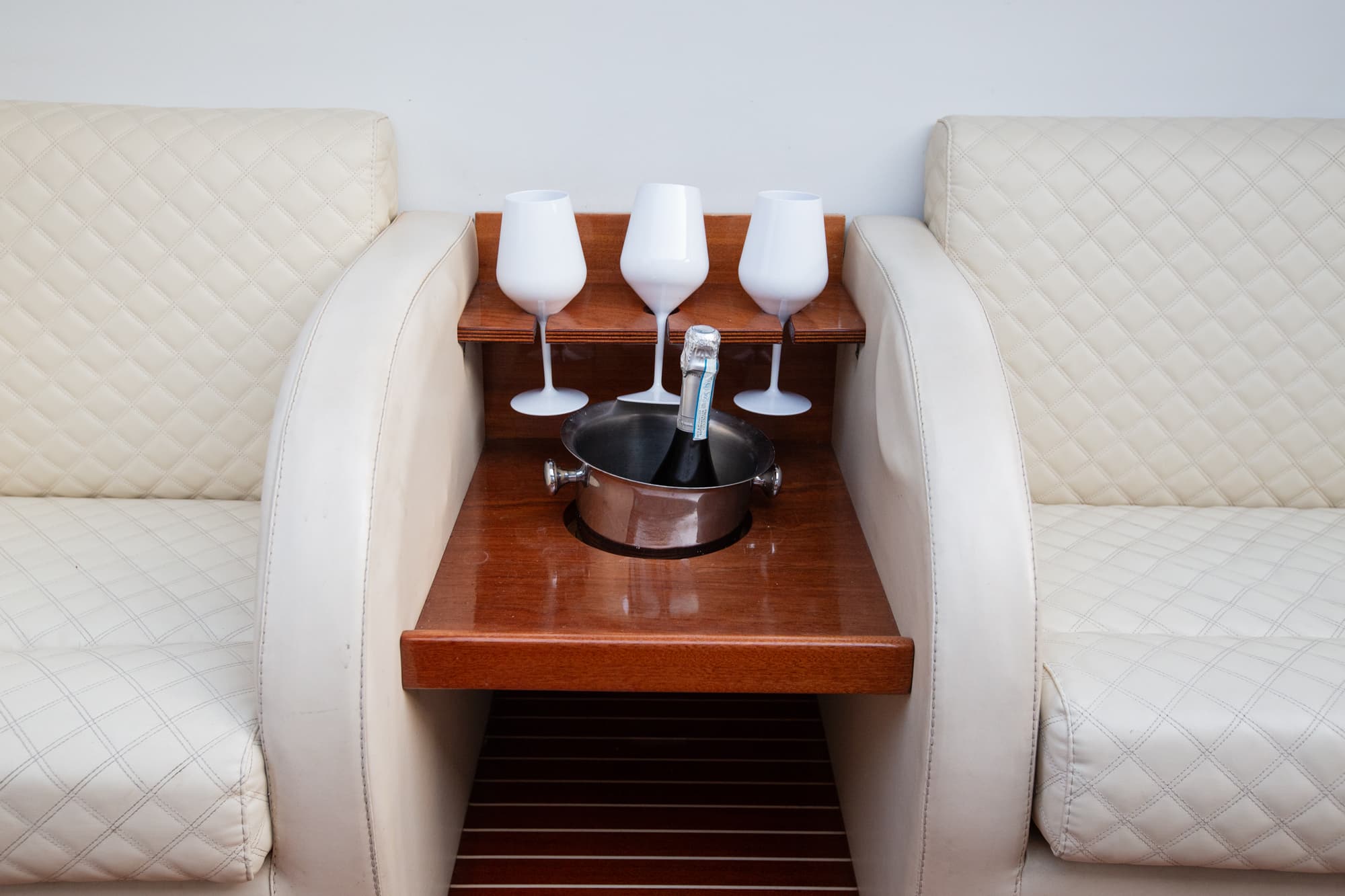Luxury wooden boat docked on Lake Como with drinks