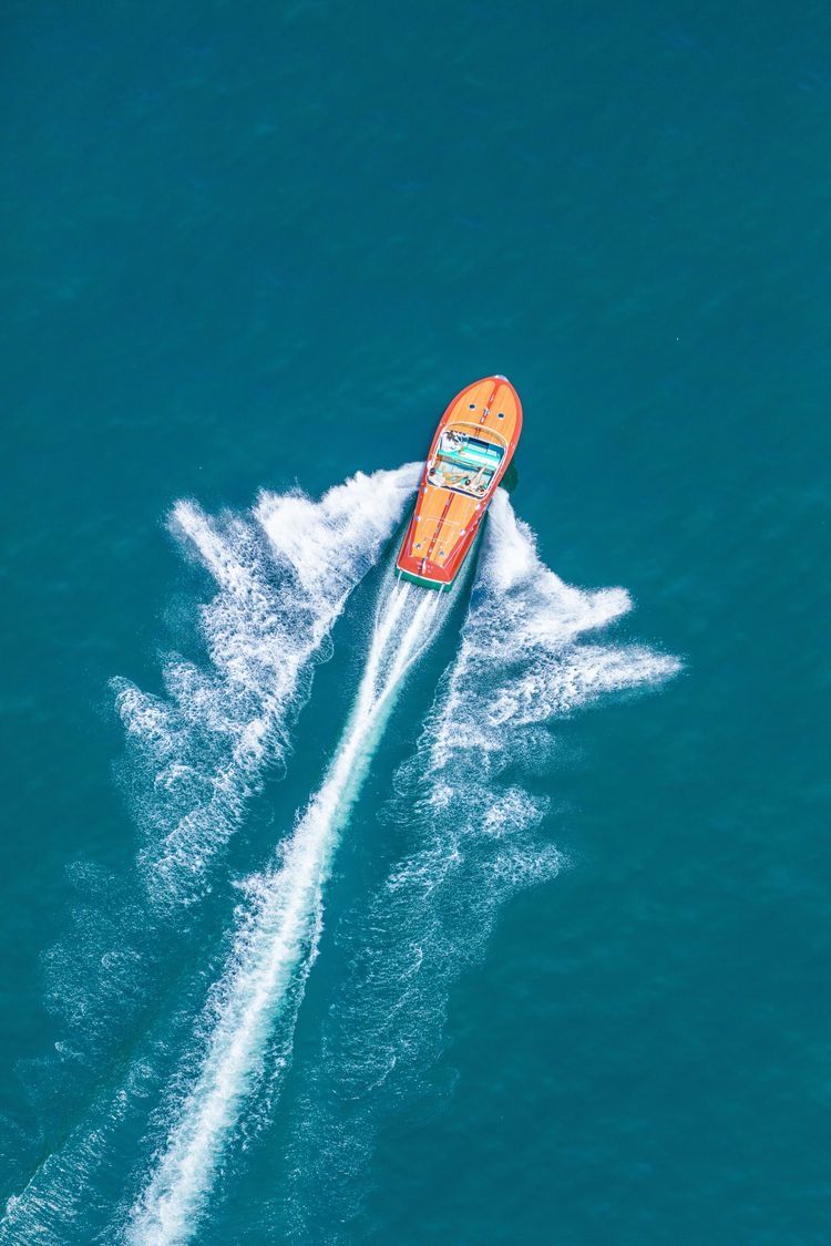 Aerial view of a luxury speedboat cruising on the blue waters of Lake Como
